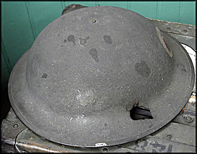 This helmet saved the life of Captain William Cadwallader during the Battle of Argonne during World War I. You can see where the bullet went through it.