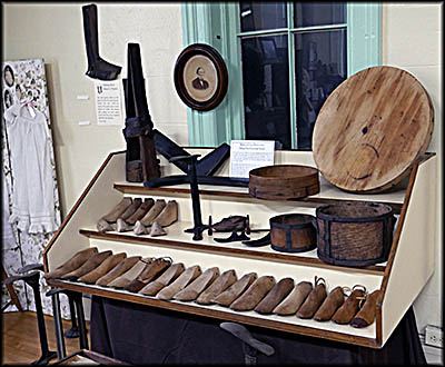 These are tools and lasts (the wooden shapes over which shoes were constructed) that Alonzo Drake would have used to make shoes.