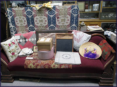 Woodville Historical Museum Upon this sofa are a number of artifacts.